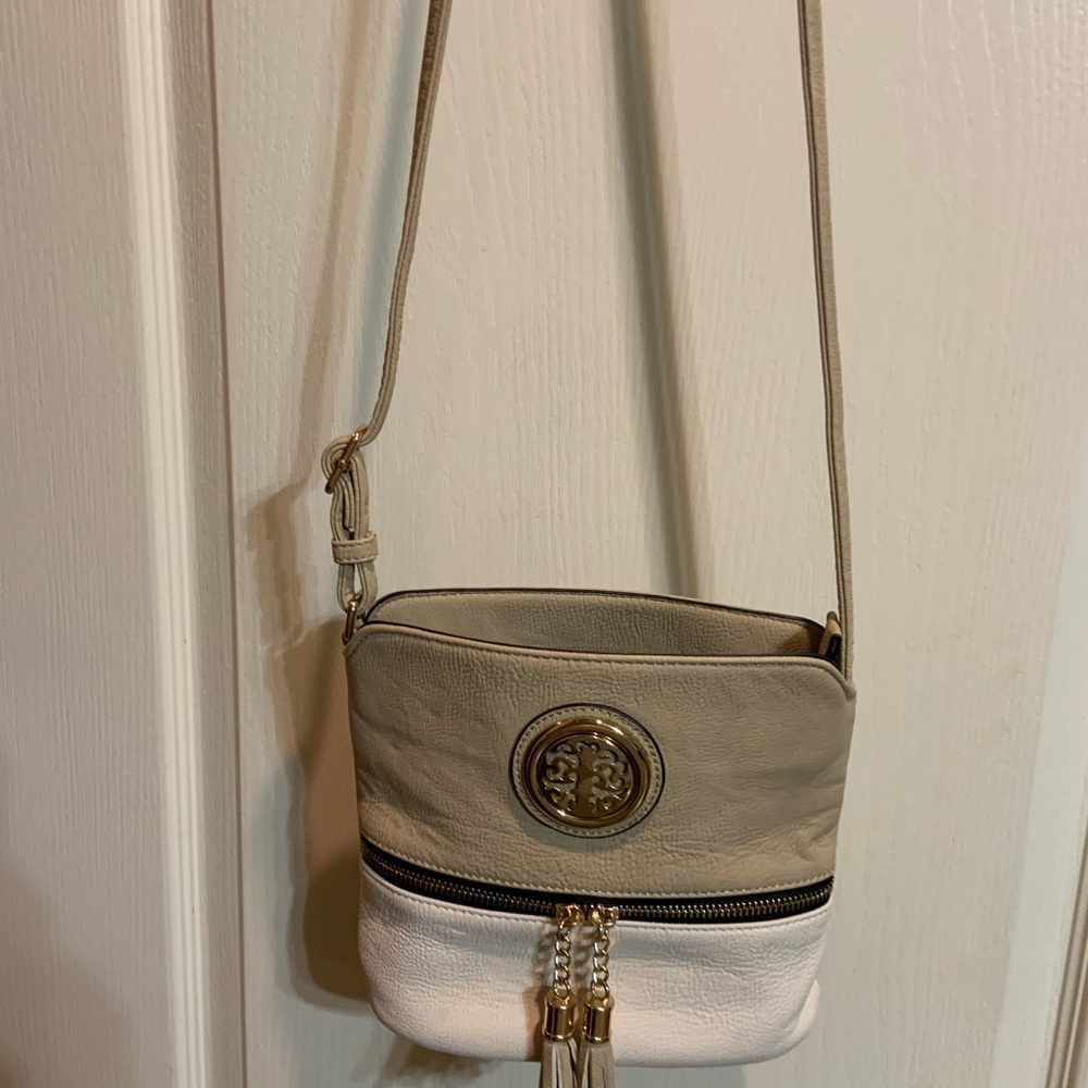 Tan and White Crossbody Bag with Tassel Detail.  Gently used. Width 9”x 7.5” Len